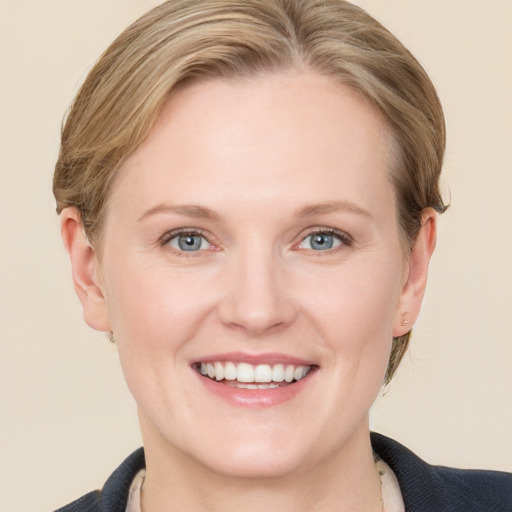 Joyful white young-adult female with medium  brown hair and blue eyes