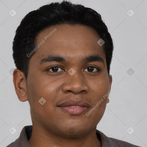 Joyful black young-adult male with short  black hair and brown eyes