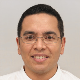Joyful white adult male with short  black hair and brown eyes