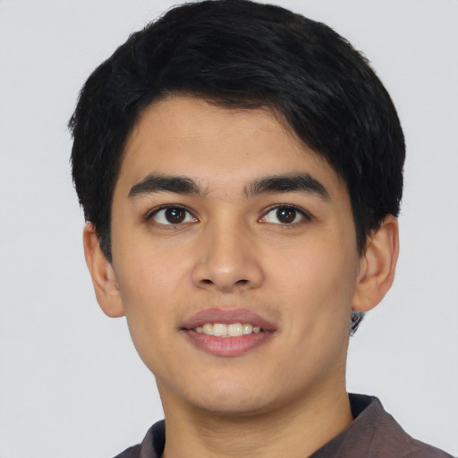 Joyful asian young-adult male with short  black hair and brown eyes