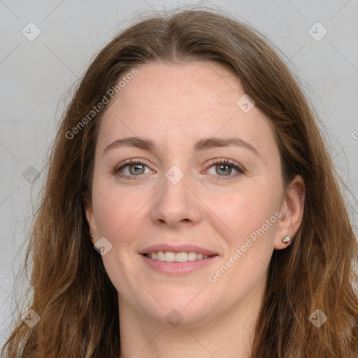 Joyful white adult female with long  brown hair and green eyes