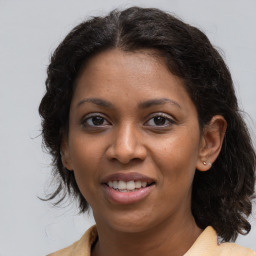 Joyful black young-adult female with medium  brown hair and brown eyes