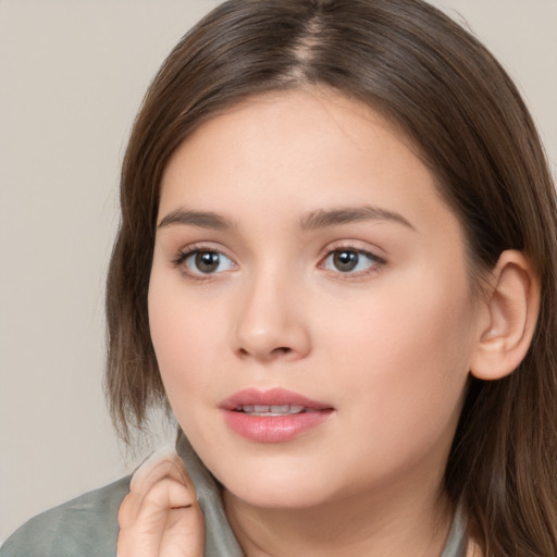 Neutral white young-adult female with long  brown hair and brown eyes