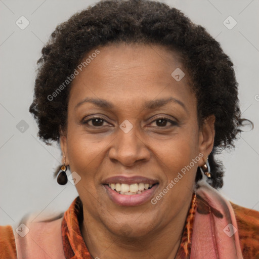 Joyful black adult female with short  brown hair and brown eyes