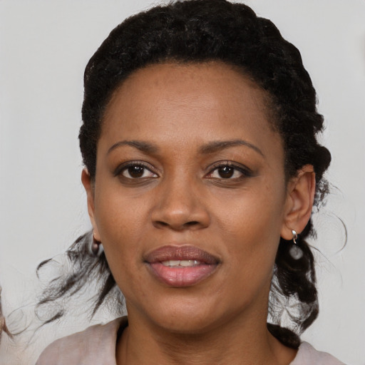 Joyful black adult female with medium  black hair and brown eyes