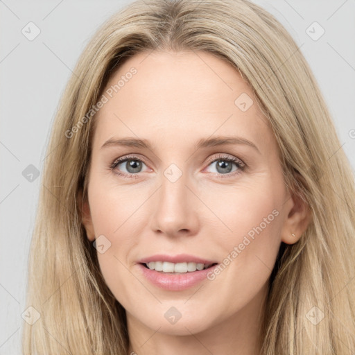 Joyful white young-adult female with long  brown hair and blue eyes