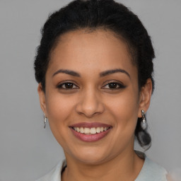 Joyful latino young-adult female with short  brown hair and brown eyes