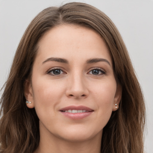 Joyful white young-adult female with long  brown hair and grey eyes