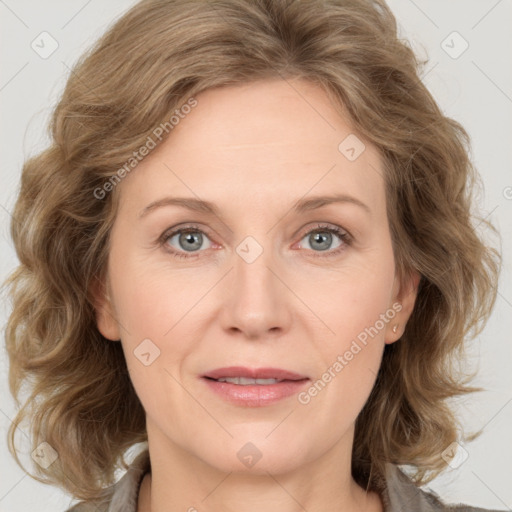 Joyful white adult female with medium  brown hair and blue eyes