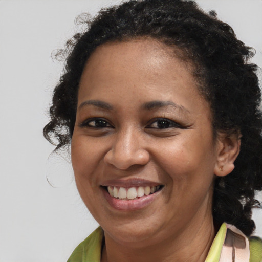 Joyful black young-adult female with medium  brown hair and brown eyes