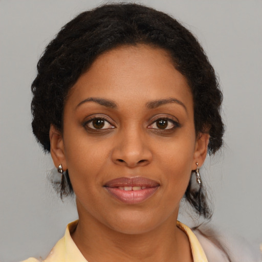 Joyful black young-adult female with medium  brown hair and brown eyes