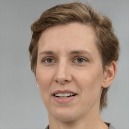 Joyful white adult female with medium  brown hair and grey eyes