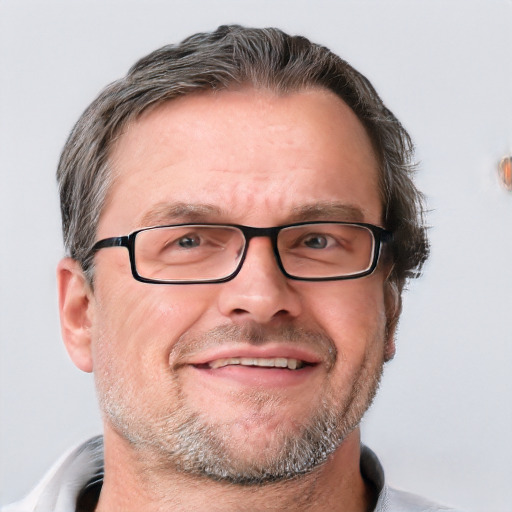 Joyful white middle-aged male with short  brown hair and blue eyes