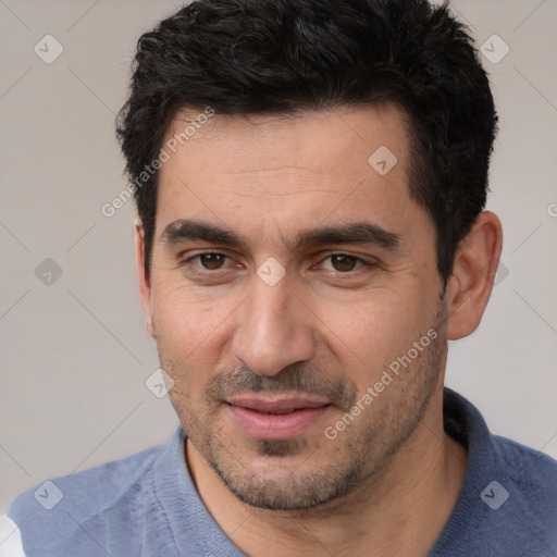 Joyful white young-adult male with short  black hair and brown eyes