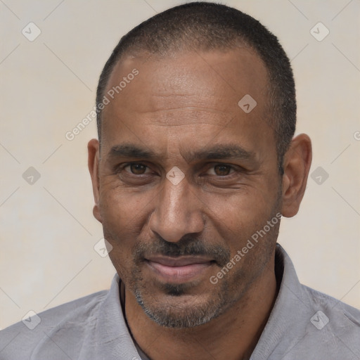 Joyful white adult male with short  black hair and brown eyes