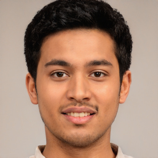 Joyful latino young-adult male with short  brown hair and brown eyes