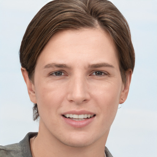 Joyful white young-adult female with short  brown hair and grey eyes