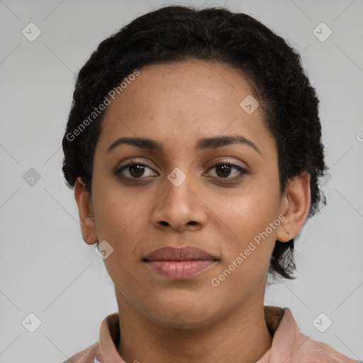 Joyful black young-adult female with short  brown hair and brown eyes