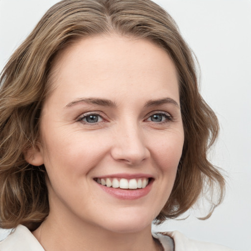 Joyful white young-adult female with medium  brown hair and green eyes