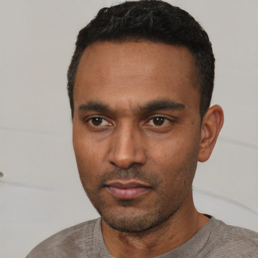Neutral latino young-adult male with short  black hair and brown eyes
