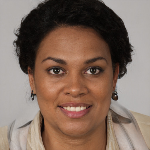 Joyful black young-adult female with medium  brown hair and brown eyes