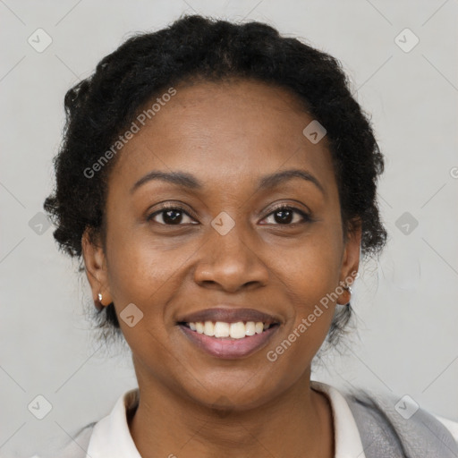 Joyful black adult female with short  brown hair and brown eyes