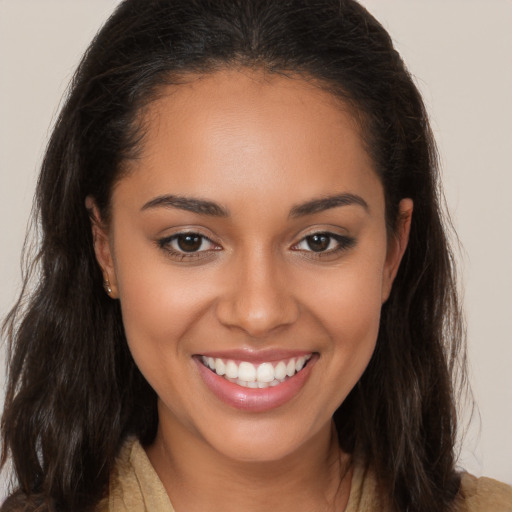 Joyful latino young-adult female with long  brown hair and brown eyes