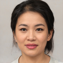 Joyful asian young-adult female with medium  brown hair and brown eyes