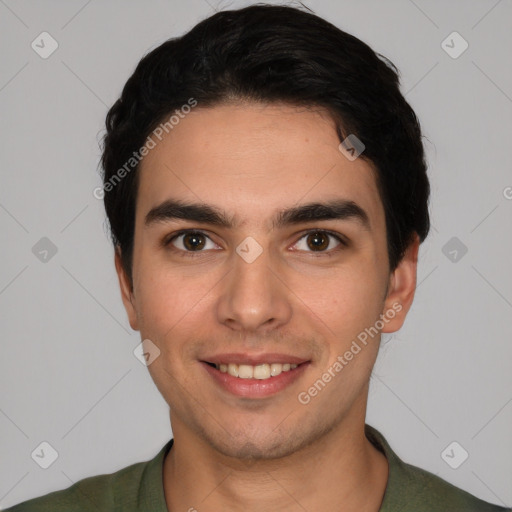 Joyful white young-adult male with short  black hair and brown eyes