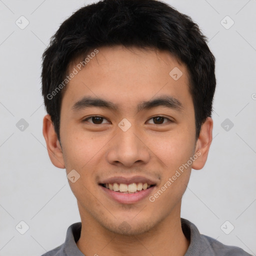 Joyful asian young-adult male with short  brown hair and brown eyes