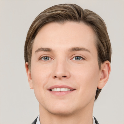 Joyful white young-adult male with short  brown hair and grey eyes