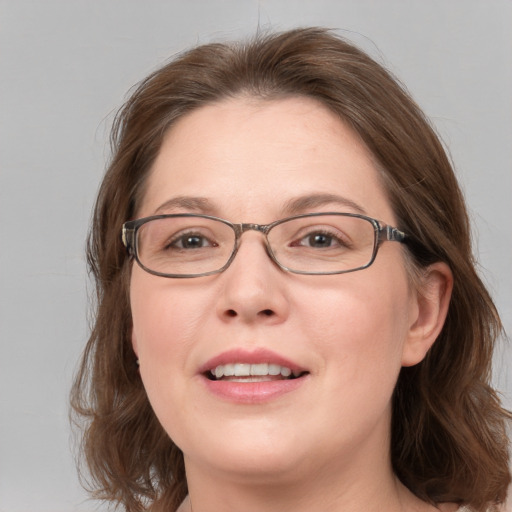 Joyful white adult female with medium  brown hair and blue eyes