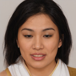 Joyful asian young-adult female with medium  brown hair and brown eyes