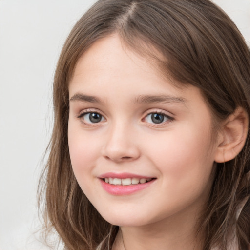 Joyful white child female with long  brown hair and brown eyes