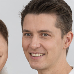 Joyful white adult male with short  brown hair and brown eyes