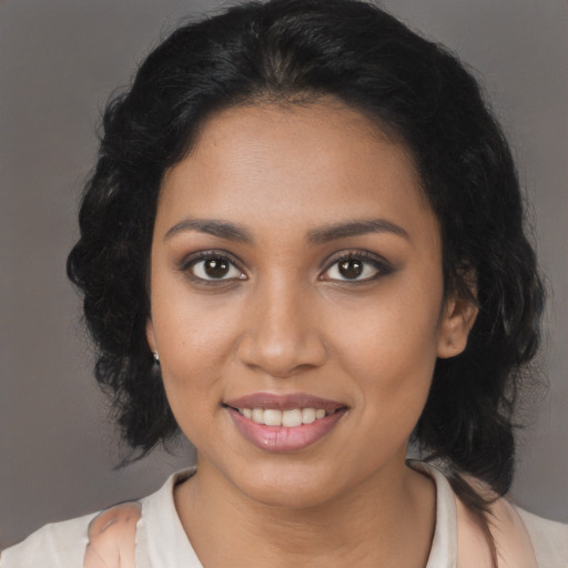 Joyful latino young-adult female with medium  brown hair and brown eyes
