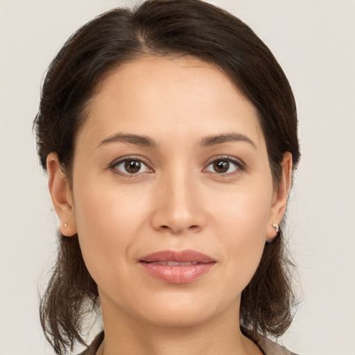 Joyful white young-adult female with medium  brown hair and brown eyes