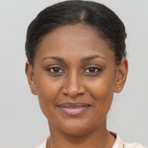 Joyful black young-adult female with short  brown hair and brown eyes