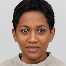 Joyful black young-adult female with short  brown hair and brown eyes