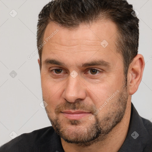 Joyful white adult male with short  brown hair and brown eyes