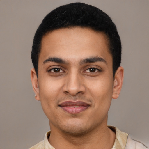 Joyful latino young-adult male with short  black hair and brown eyes
