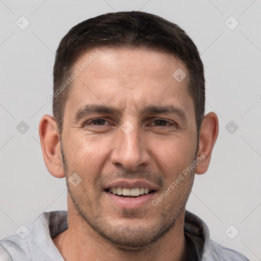 Joyful white adult male with short  brown hair and brown eyes