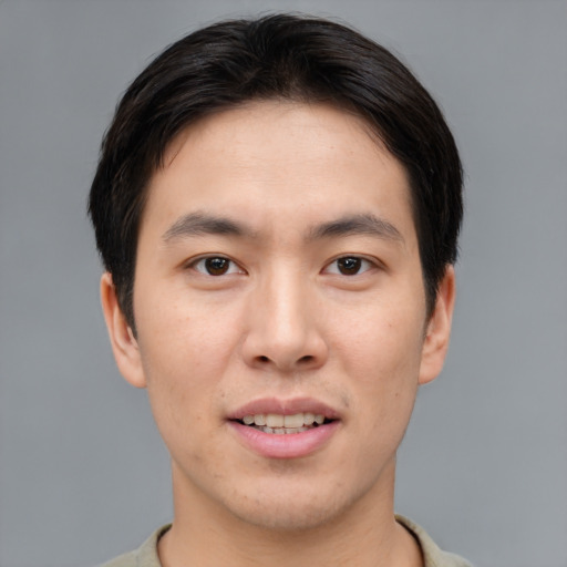Joyful asian young-adult male with short  brown hair and brown eyes