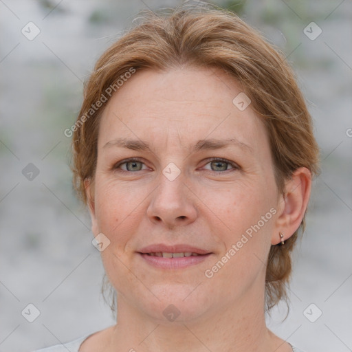 Joyful white adult female with medium  brown hair and blue eyes