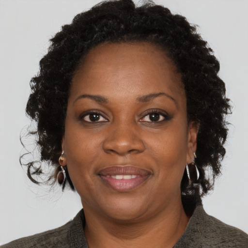 Joyful black adult female with short  brown hair and brown eyes