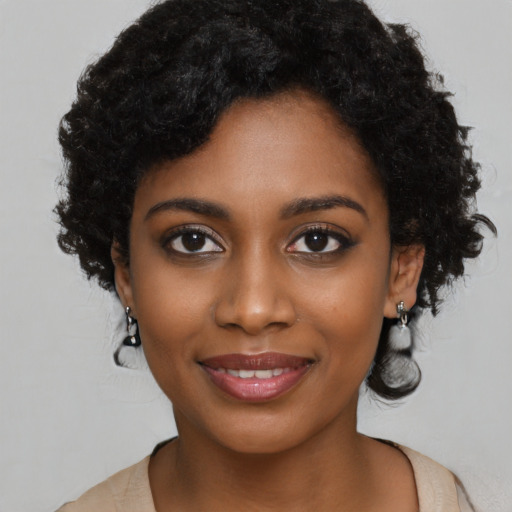 Joyful black young-adult female with long  black hair and brown eyes