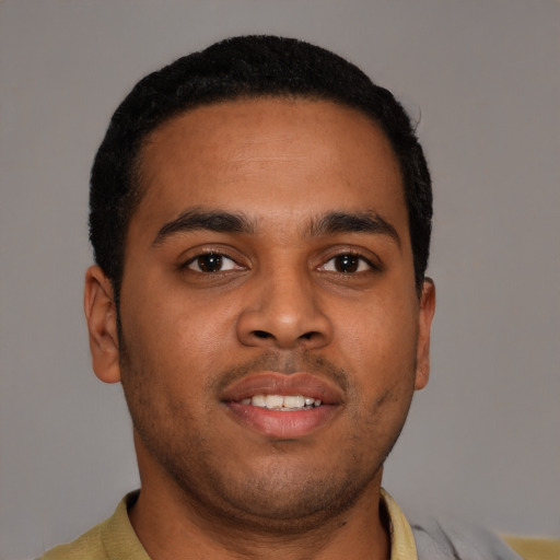 Joyful latino young-adult male with short  brown hair and brown eyes