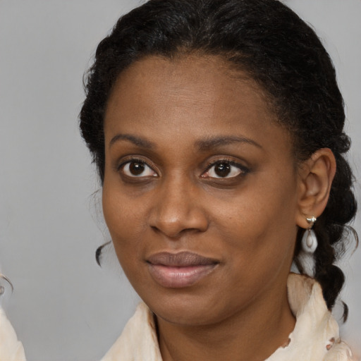 Joyful black young-adult female with medium  brown hair and brown eyes