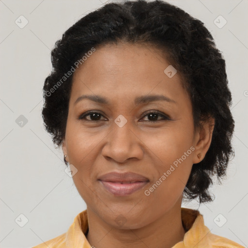 Joyful black adult female with medium  brown hair and brown eyes