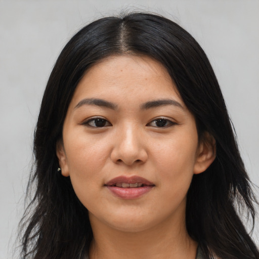 Joyful asian young-adult female with long  brown hair and brown eyes